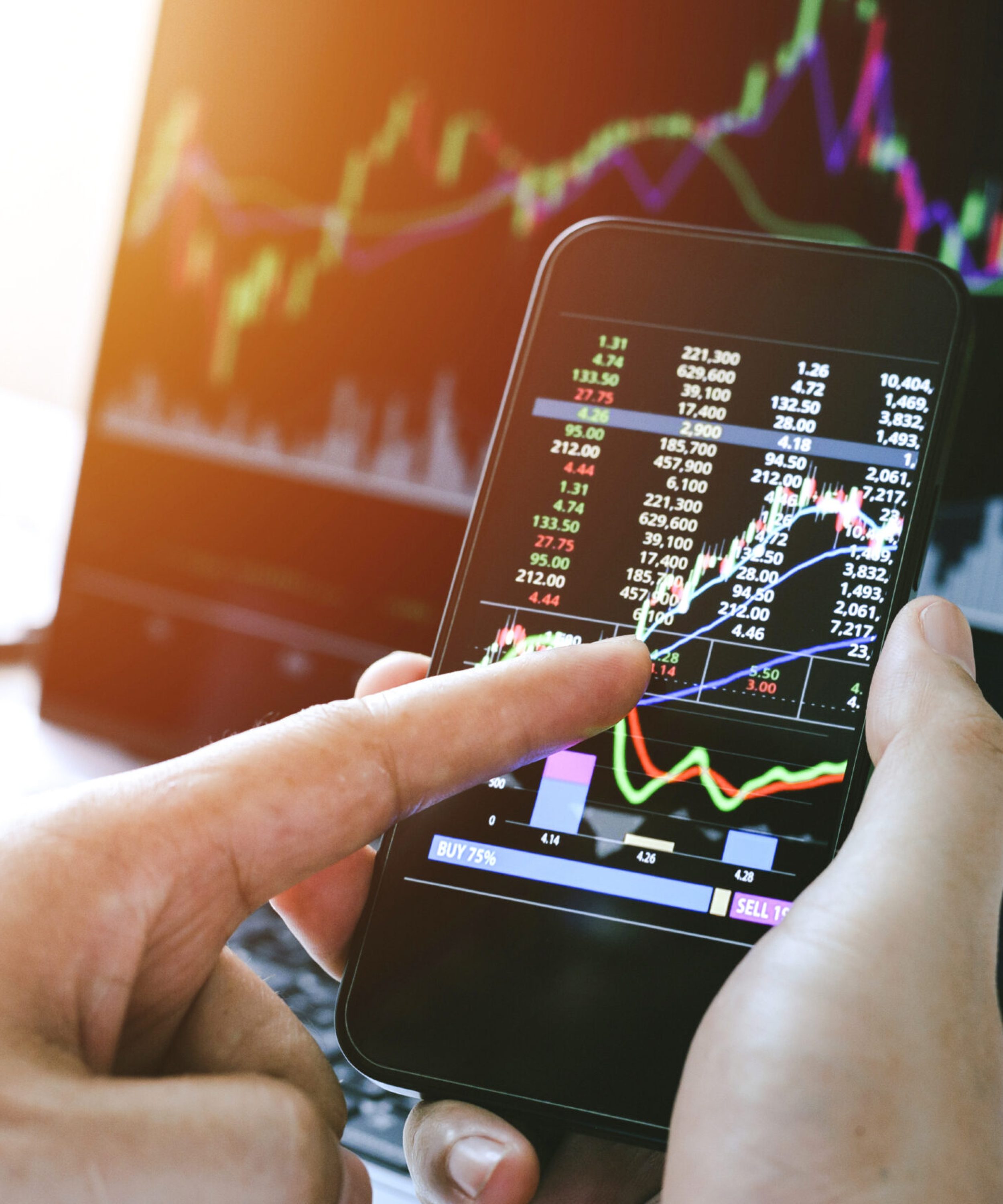 Businessman hand holding phone and analysis finance market graph stock market trading,stock chart and investment concept. Depicts TradingView financial market chart.